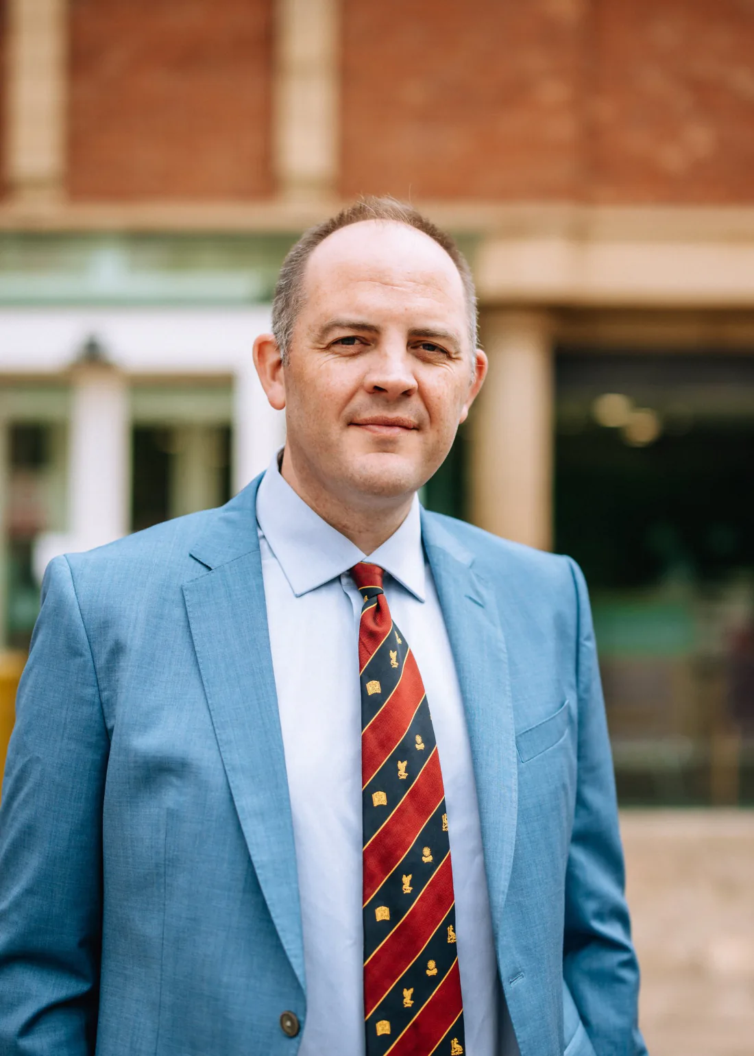 Mr Christopher West in a blue suit outside Spire Leeds Hospital.