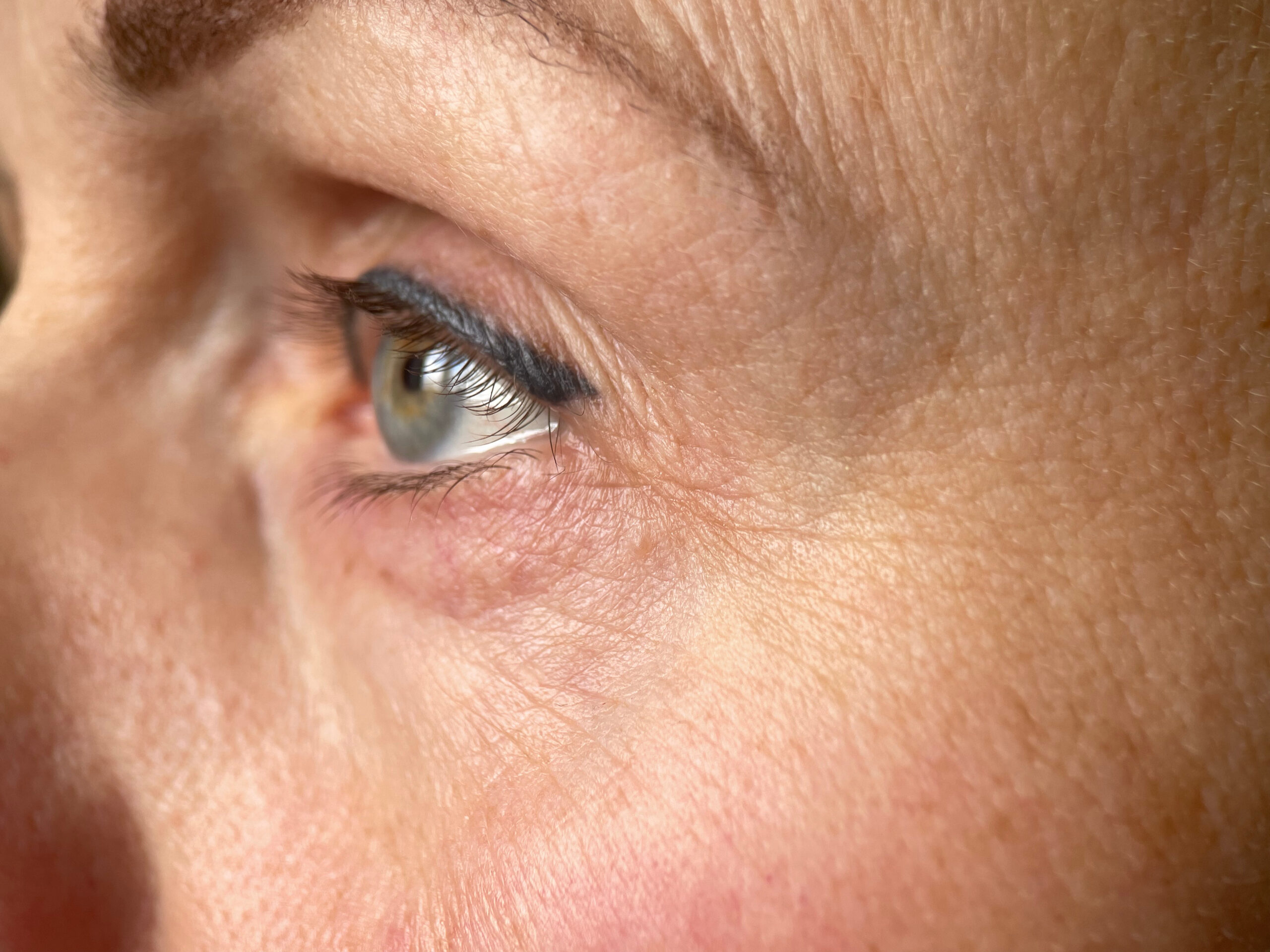 Macro Close up of an Aging Woman’s Eye with Wrinkles and Natural Skin Texture